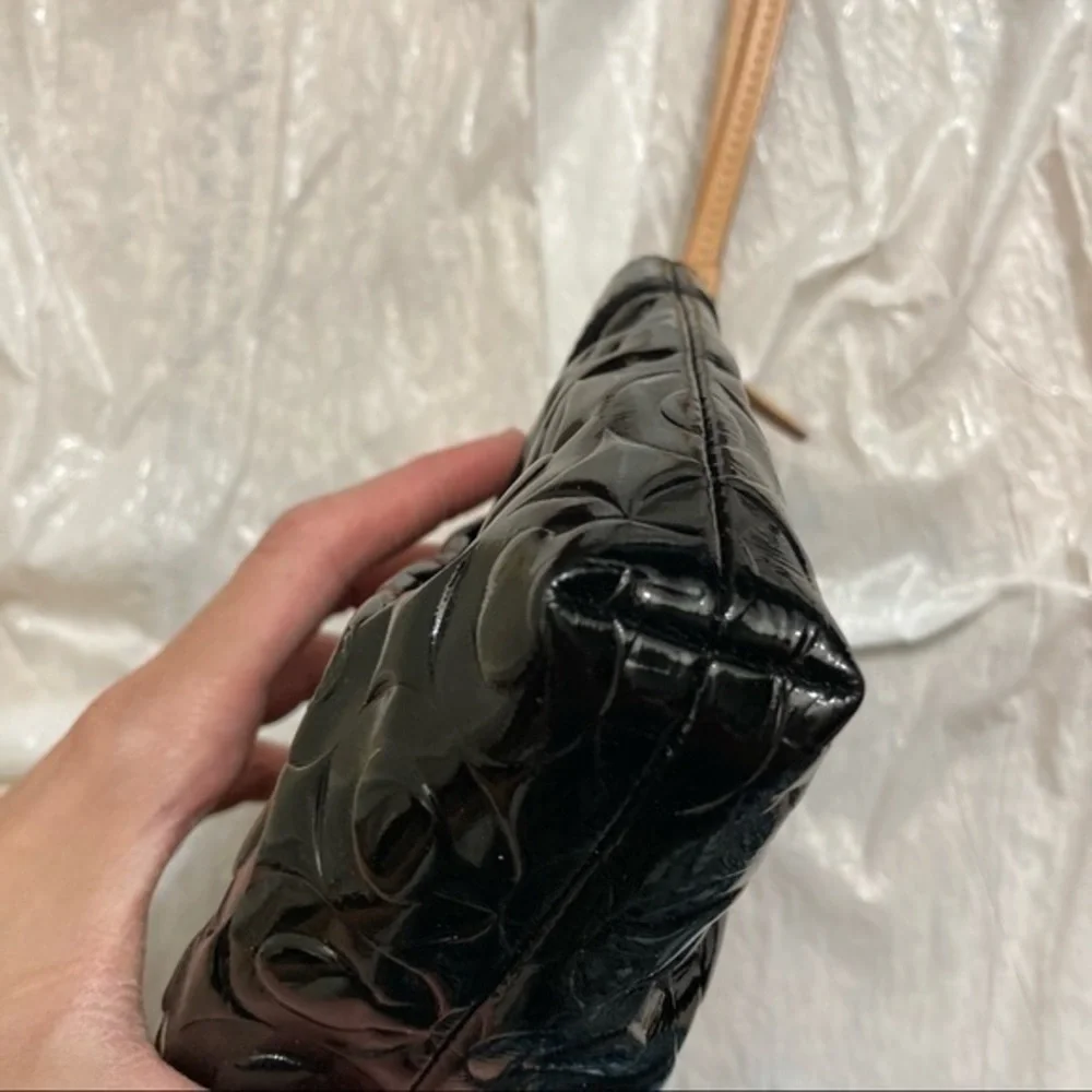Coach embossed black patent leather op art wristlet bag